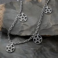Silver-colored stainless steel anklet with a cable style chain draped over rocks, featuring five cutout pentacle charms.