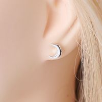 Closeup of a Silver New Moon Post Earring in a model's ear, showing its small size and simple beauty.