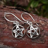 Sterling silver Domed Pentacle Earrings on a rustic backdrop of tree bark, their polished finish catching the light.