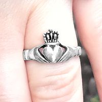 Closeup of the Silver Irish Claddagh Ring on a finger, emphasizing its delicate design and comfortable fit.