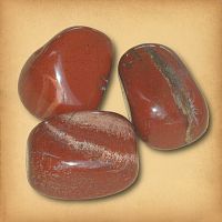 Three tumbled Red Jasper stones, in a brick red hue with some streaking, demonstrating the typical variety in a set.