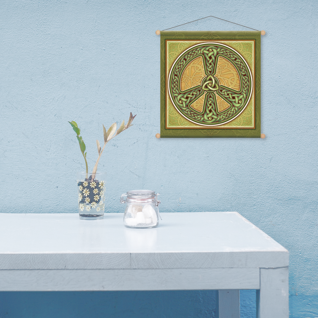 Minimalist scene evoking tranquility, an almost bare tabletop, and the Celtic Peace banner hanging on a pale blue wall.