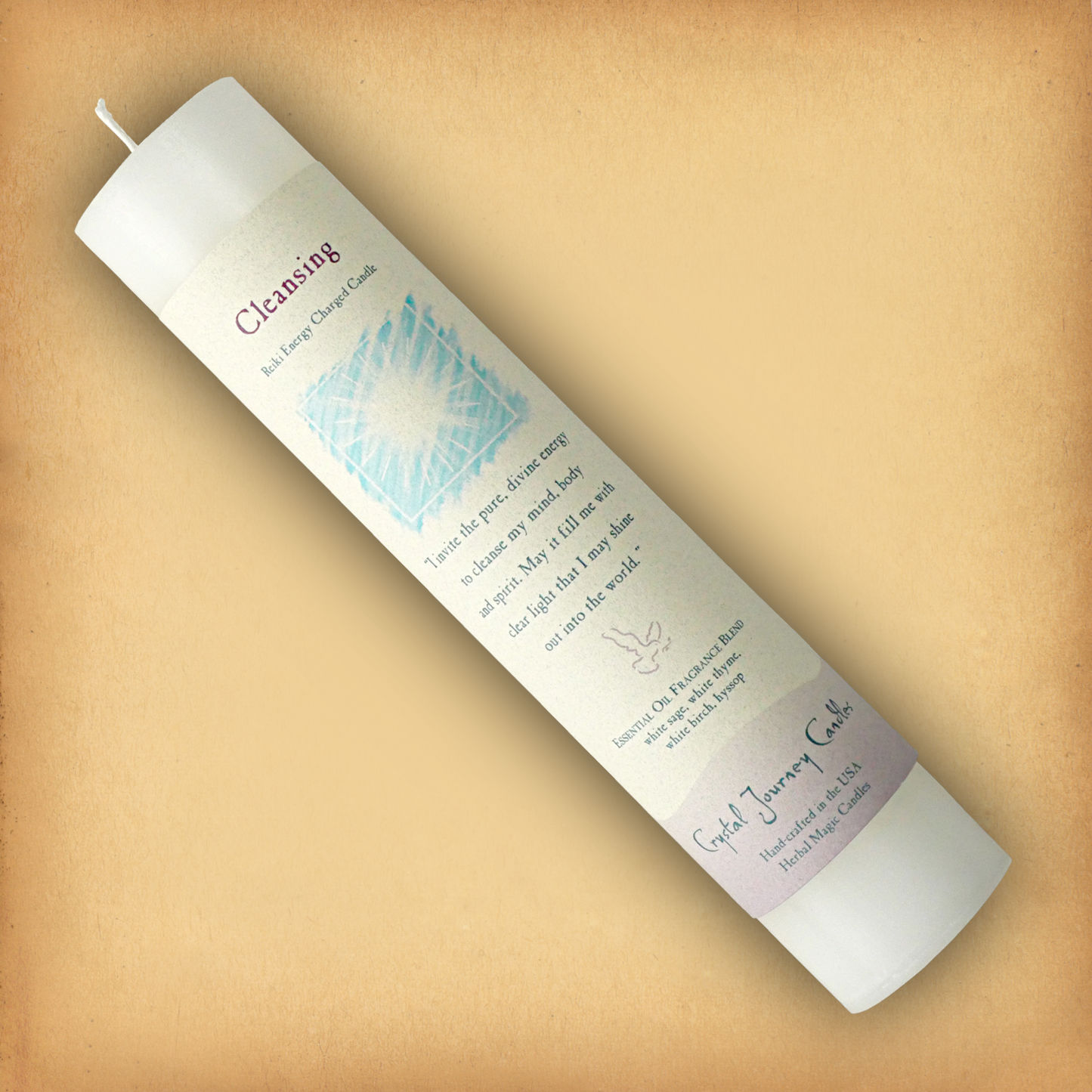White Reiki-charged Cleansing Pillar Candle, displayed diagonally to show its label with affirmation and essential oil blend.