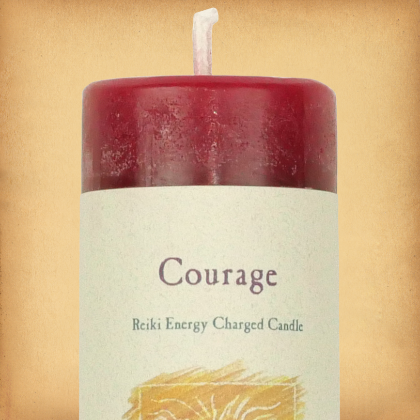 Red pillar candle labeled “Courage” with “Reiki Energy Charged Candle” beneath. Slim pillar candle with a single wick.