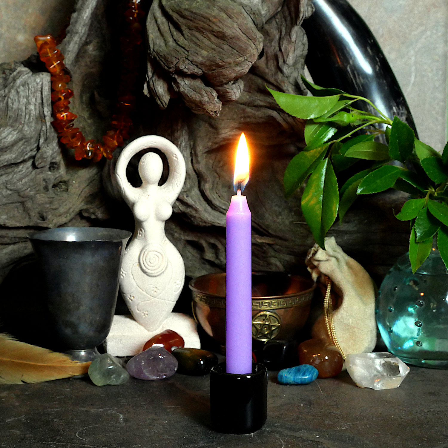 A lit Lavender Chime Candle, in a personal altar display, showing how it might be used in a ritual or ceremonial setting.