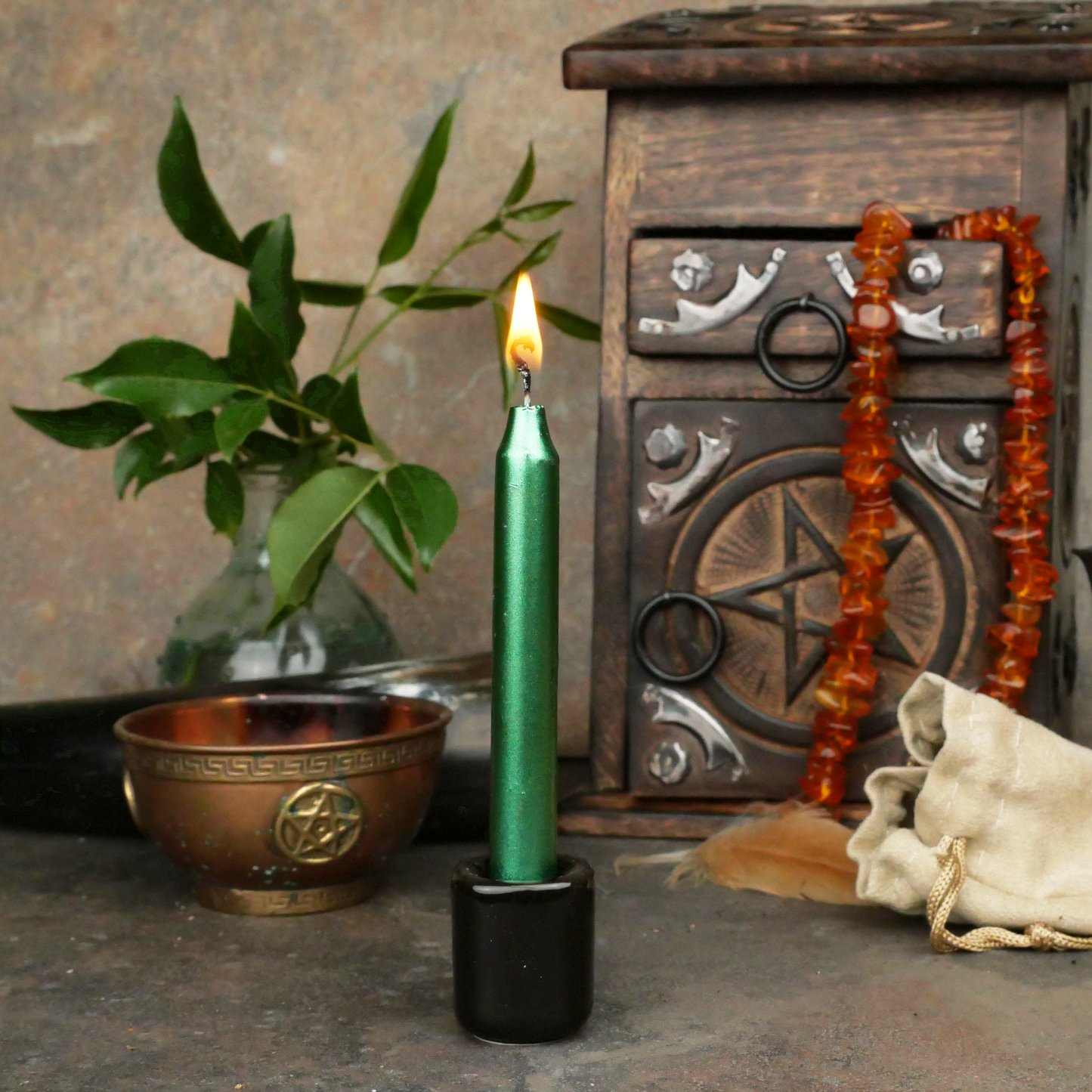 Lit Metallic Green Chime Candle, in a personal altar display, showing how it might be used in a ritual or ceremonial setting.