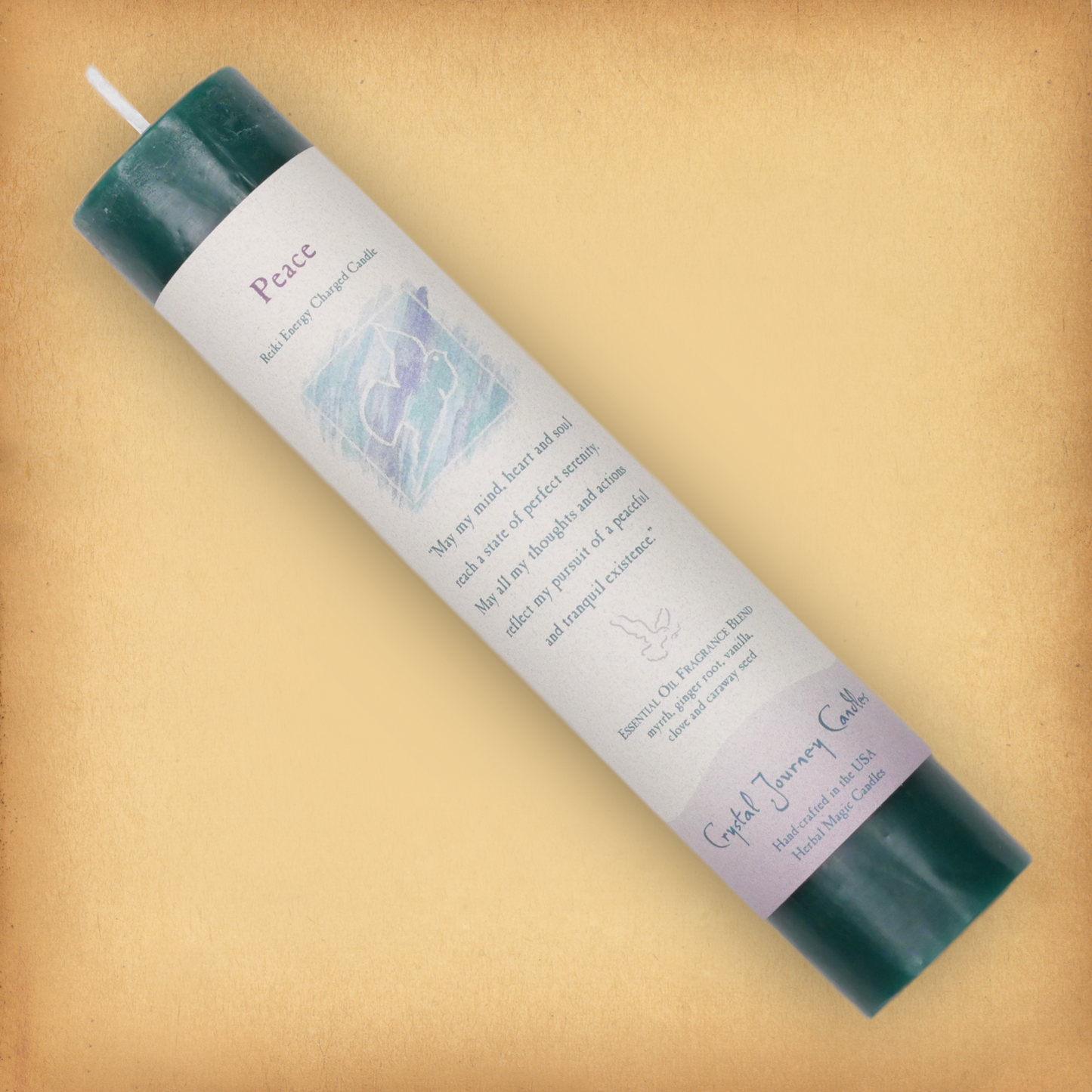 Green Reiki-charged Peace Pillar Candle, displayed diagonally to show its label with affirmation and essential oil blend.