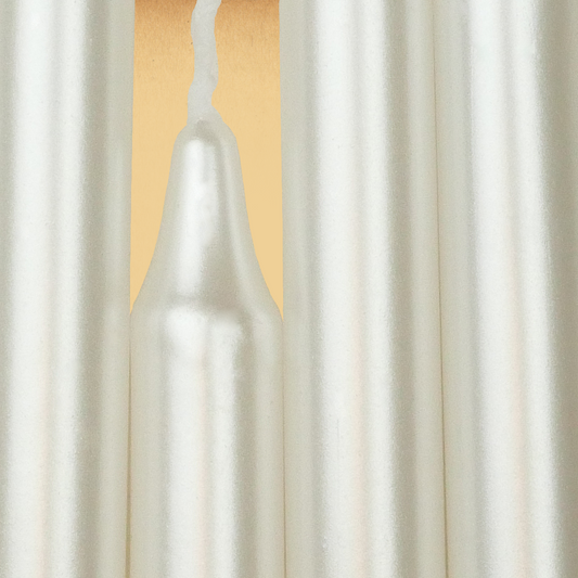Closeup of a quartet of Pearl White Chime Candles arranged side-by-side so they form an almost solid block of color.