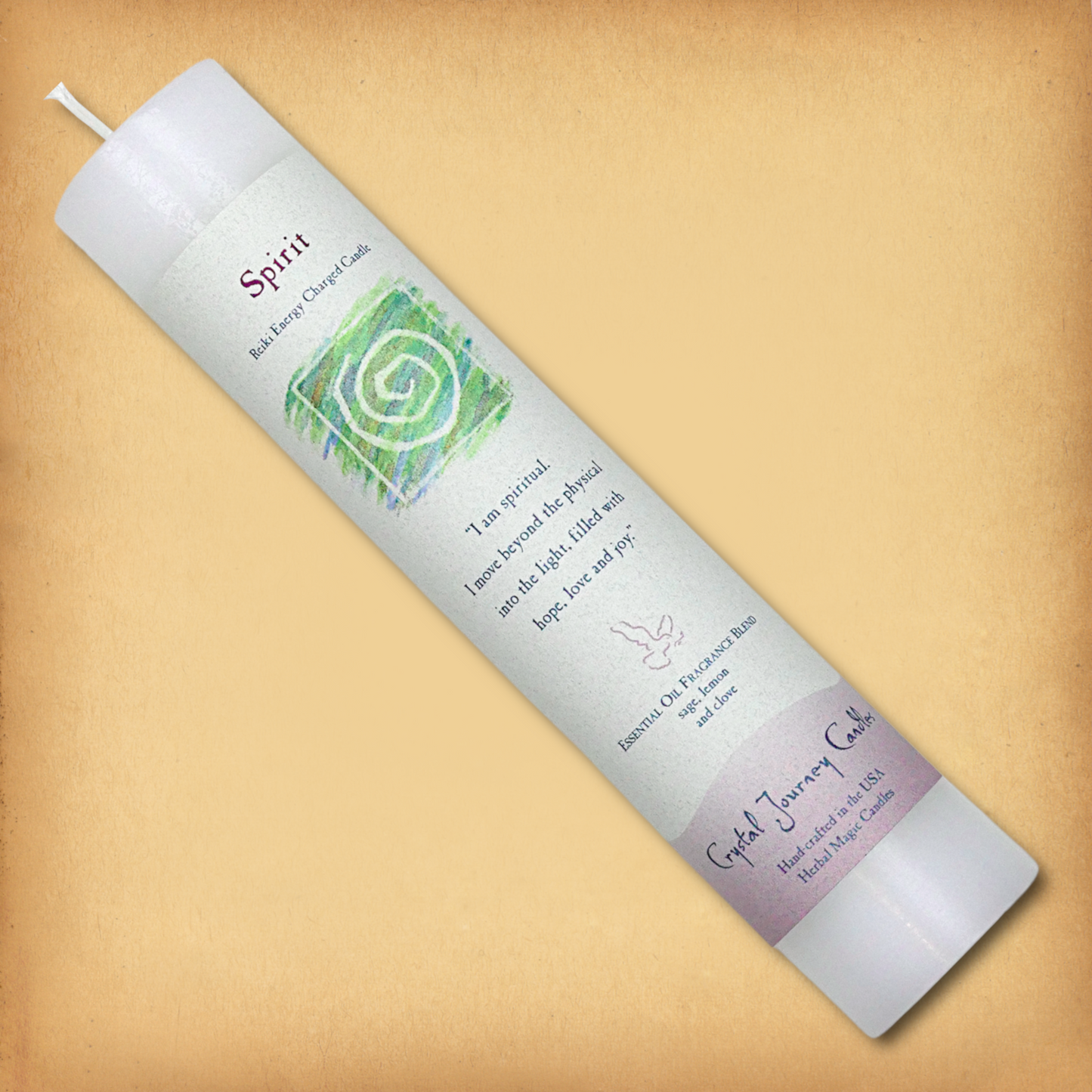 White Reiki-charged Spirit Pillar Candle, displayed diagonally to show its label with affirmation and essential oil blend.