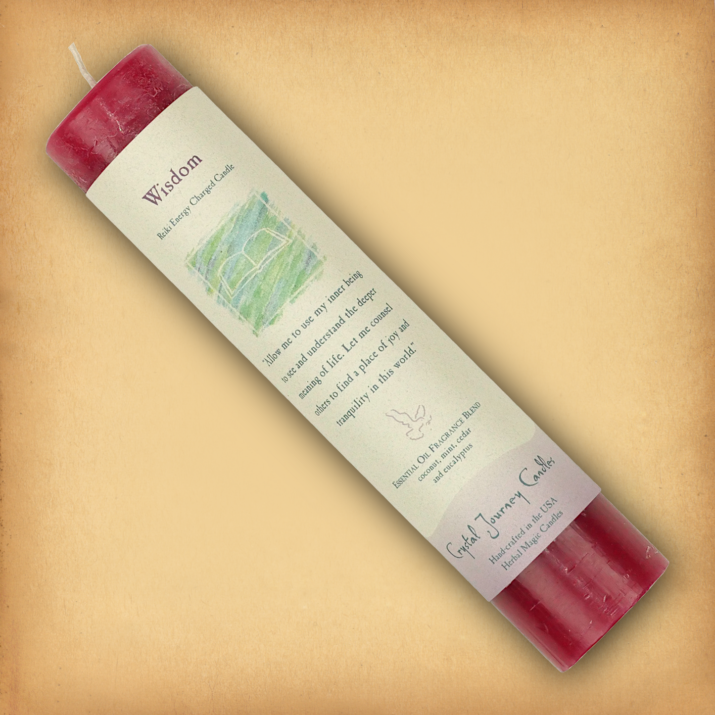 Red Reiki-charged Wisdom Pillar Candle, displayed diagonally to show its label with affirmation and essential oil blend.