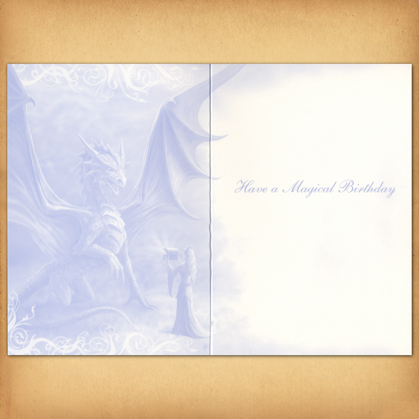 The inside of the card displays a monochromatic blue illustration of a dragon and enchantress, and "Have a Magical Birthday".