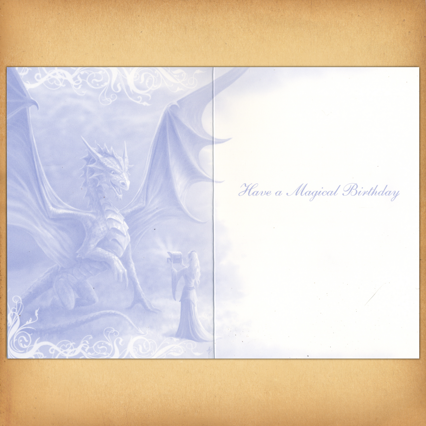 The inside of the card displays a monochromatic blue illustration of a dragon and enchantress, and "Have a Magical Birthday".