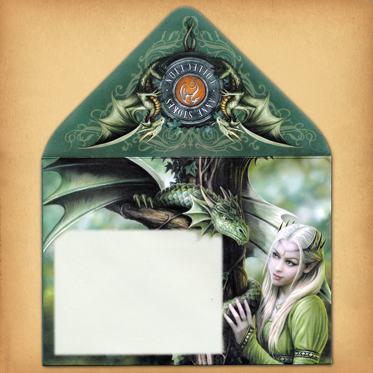 A decorative envelope featuring a green-clad elf gazing at a green dragon beneath an emblem reading "Anne Stokes Collection.