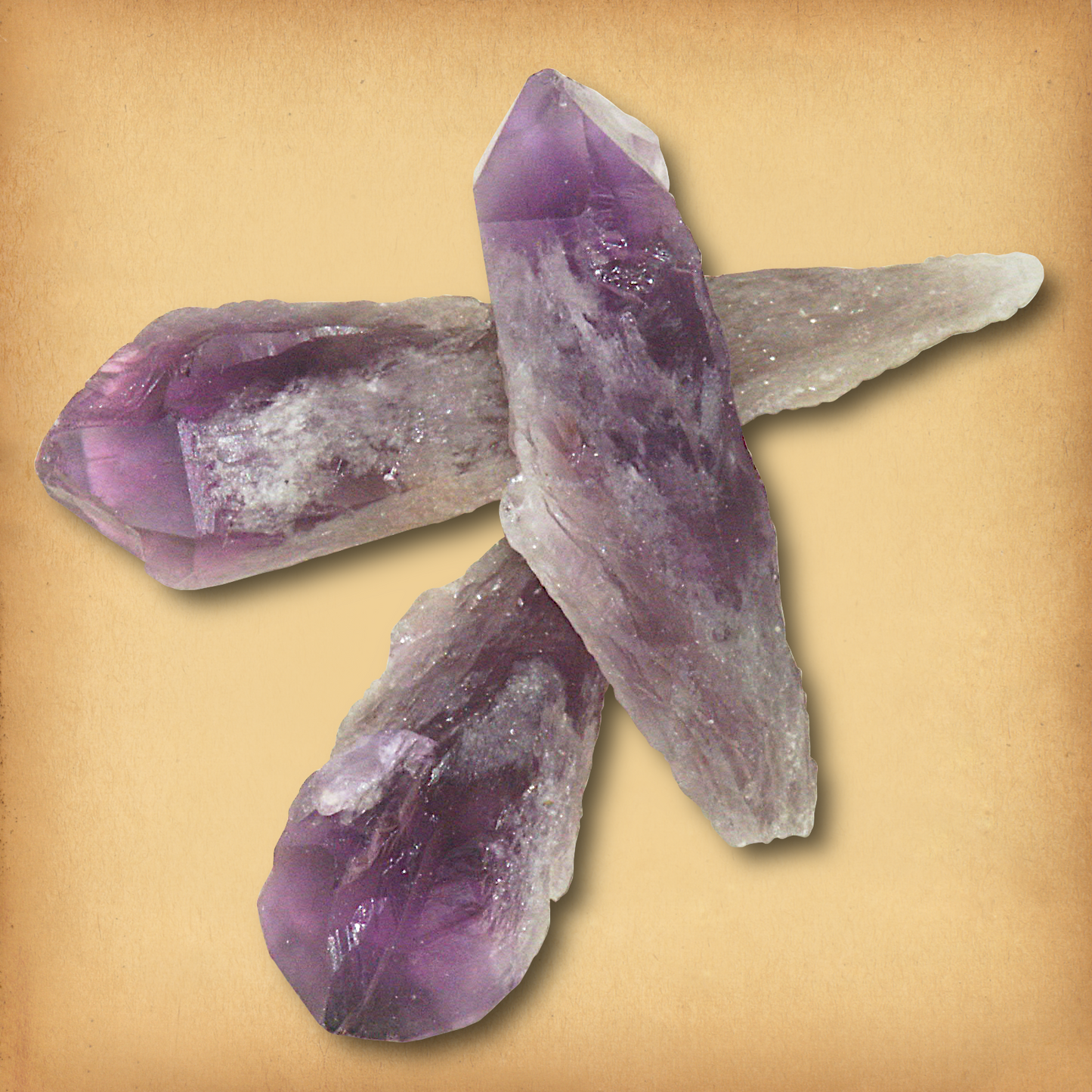 Three Amethyst gemstone lasers with deep purple terminations and rough textures demonstrating the characteristic tapered form