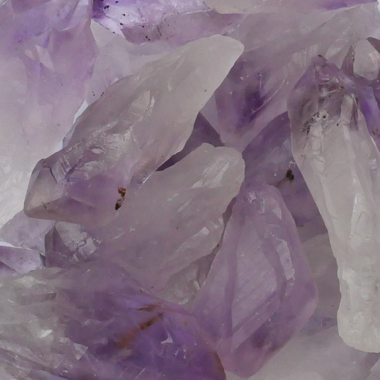 Natural Amethyst Gemstone Points  in varying shades of white and purple, highlighting their raw, naturally faceted structure