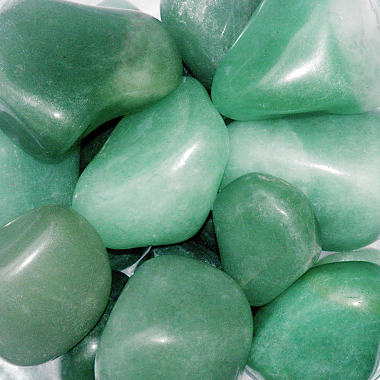 Tumbled Green Aventurine gemstones in translucent shades of milky green, with smooth surfaces and subtle natural variations.