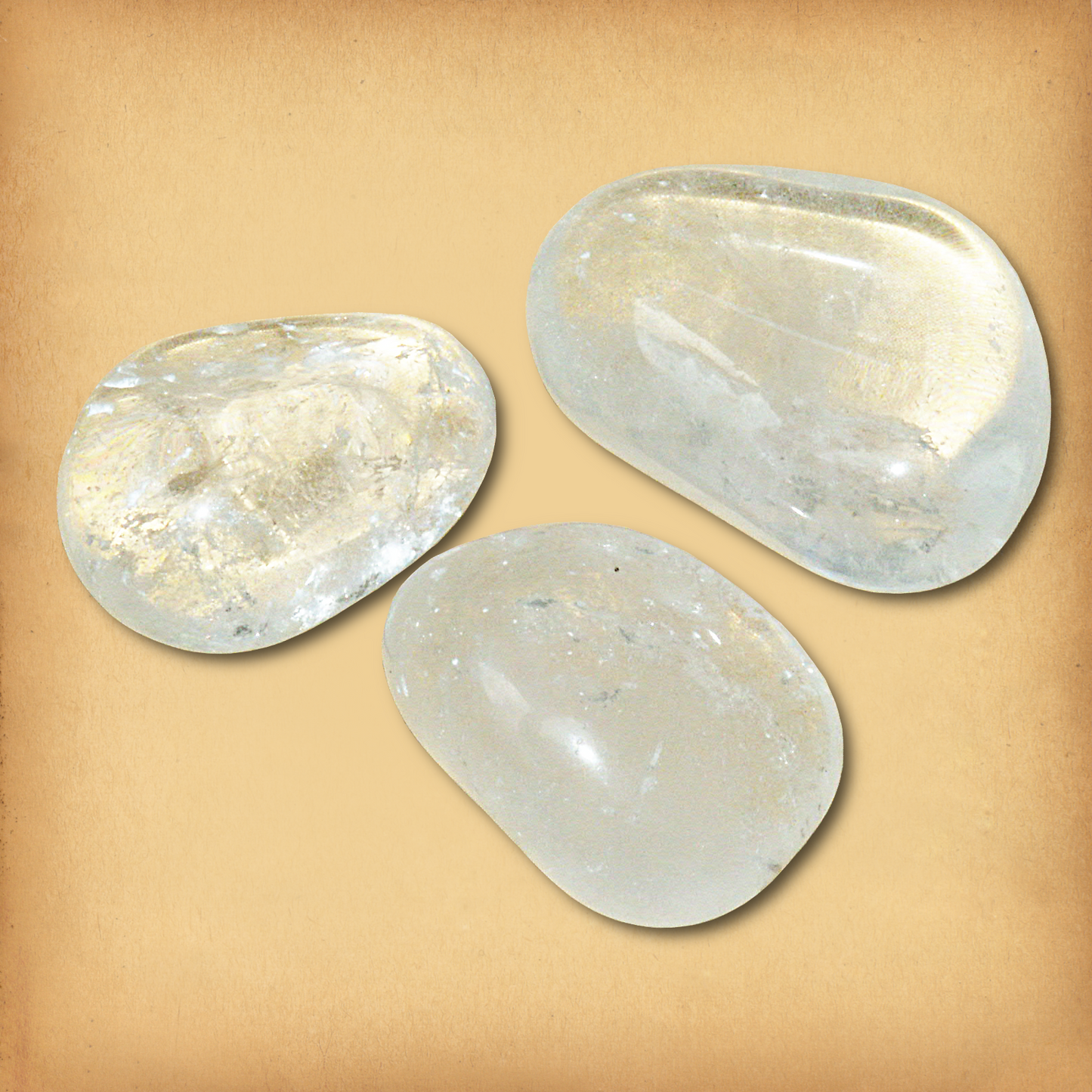 Three tumbled Clear Quartz gemstones, clear with slight milky white inclusions, demonstrating the typical variety in a set.