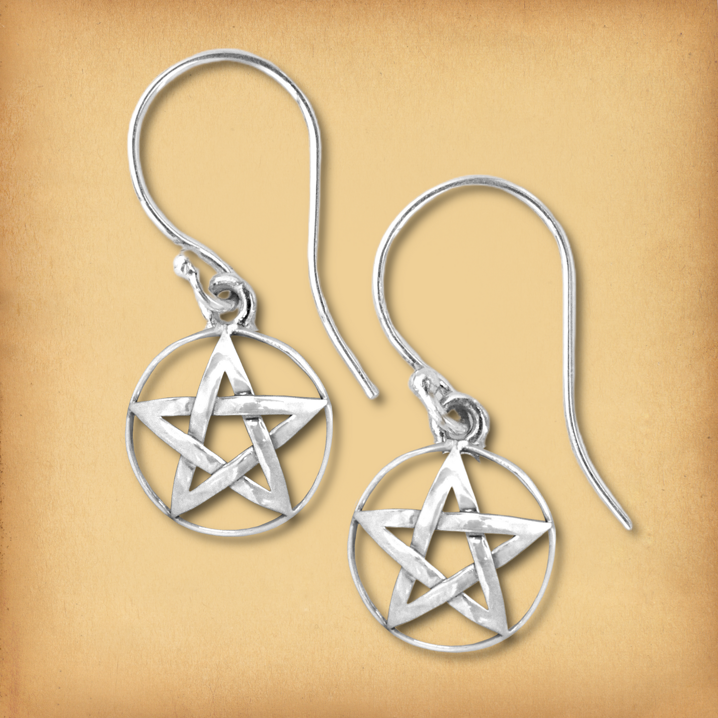 Sterling silver Domed Pentacle Earrings, showcasing the cut-out design of the 5-point star charms dangling from French hooks