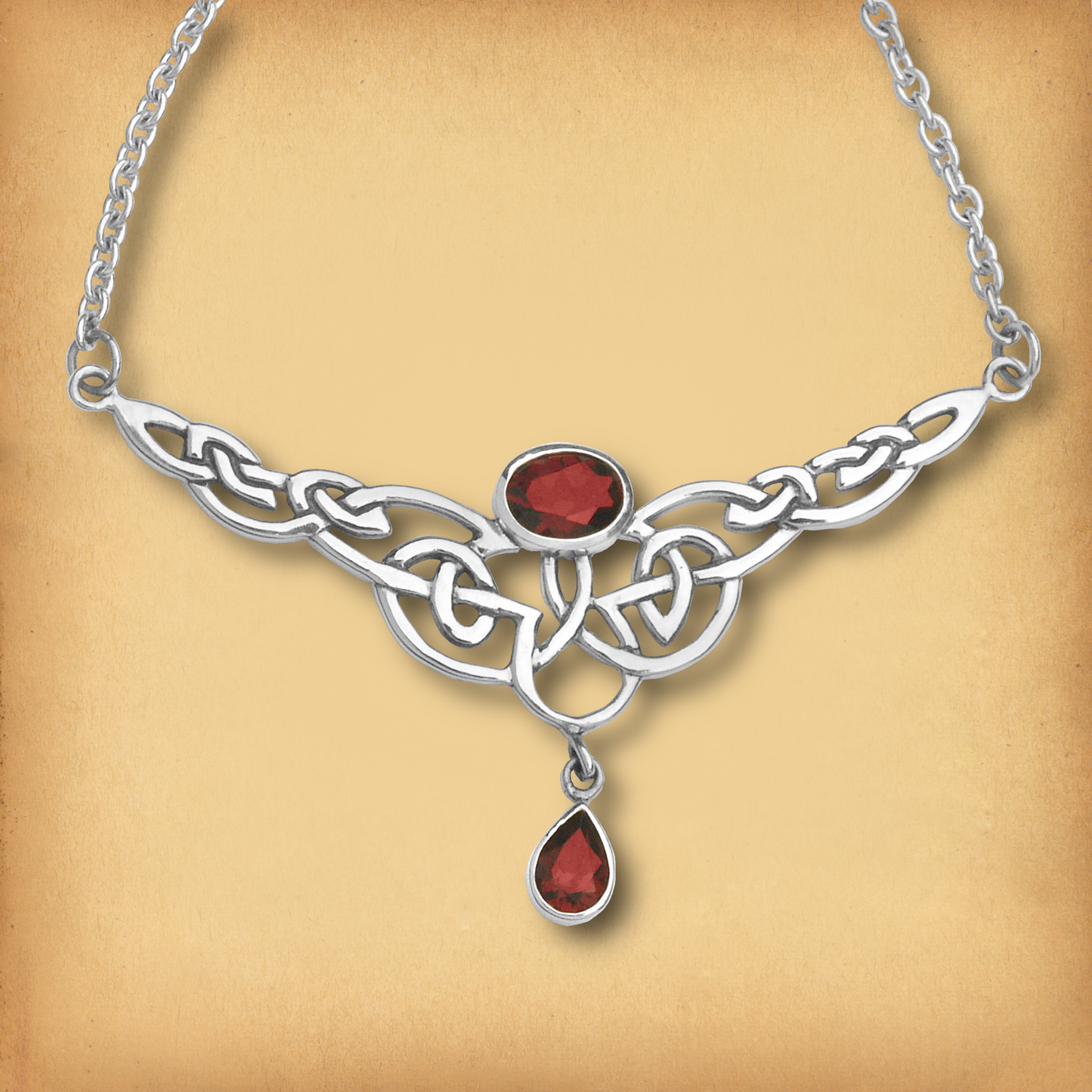 Sterling Silver Celtic Passion Necklace, showcasing Celtic knots and a pair of rich red garnet gemstones, symbolizing love.