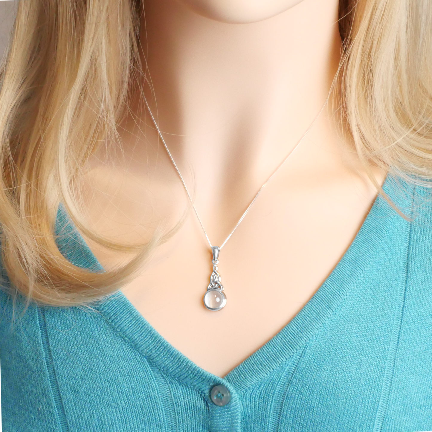 Sterling Silver Celtic Moonstone Pendant worn by a model, highlighting the detailed Celtic knot and genuine moonstone.