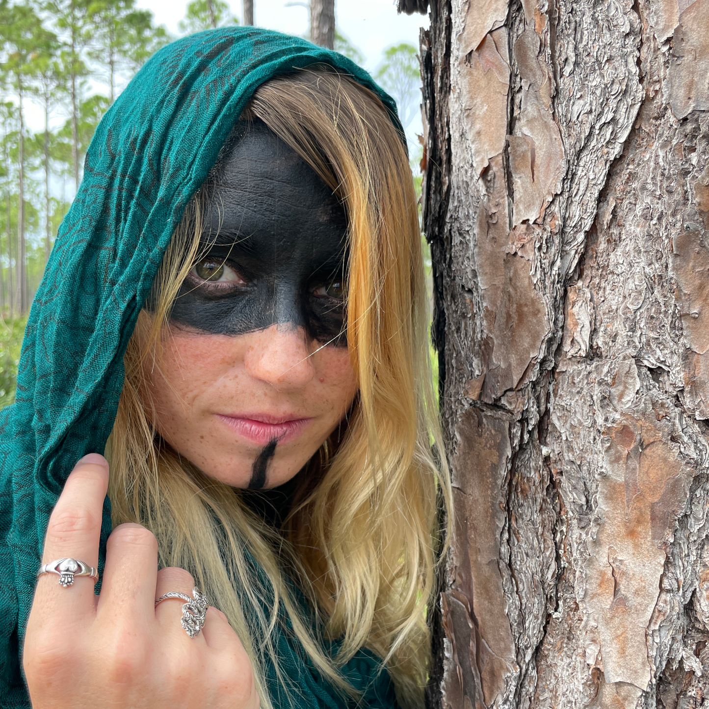 Closeup of a woman's hand, making a subtle gesture, adorned with a Silver Irish Claddagh Ring, invoking a sense of mystery.