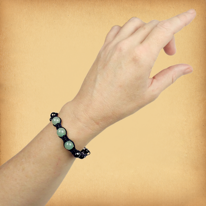 Green Aventurine Shamballa Bracelet being worn on a female wrist, showing the three larger accent beads in pastel green.