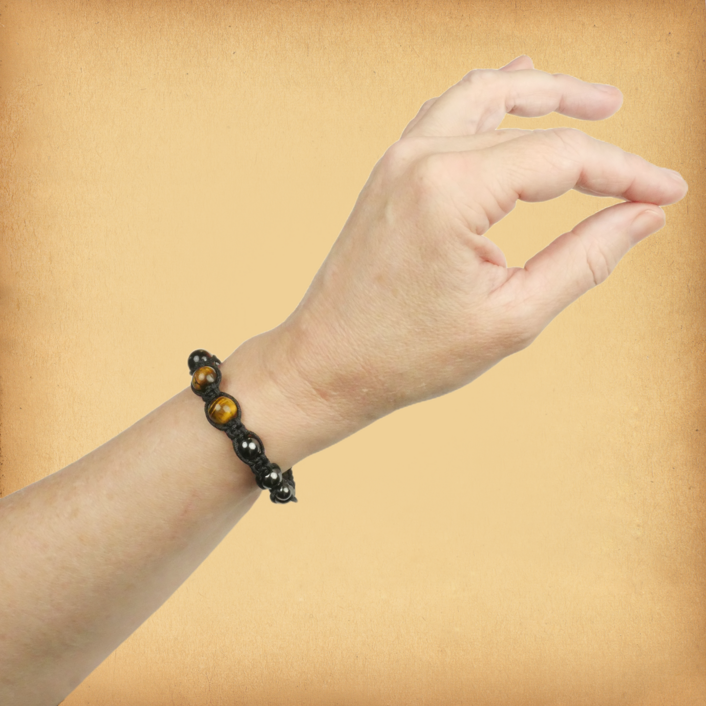Tiger Eye Shamballa Bracelet being worn on a female wrist, showing the three larger golden brown accent beads.