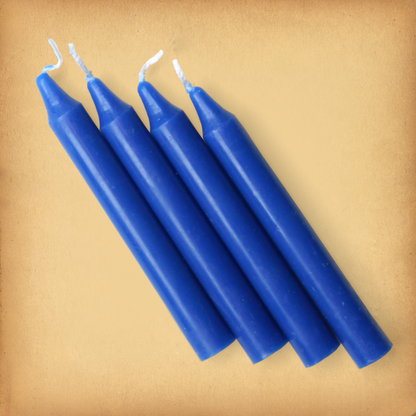 An overhead view of four royal Blue Chime Candles, diagonally placed on a plain surface, showing the candles' proportions.