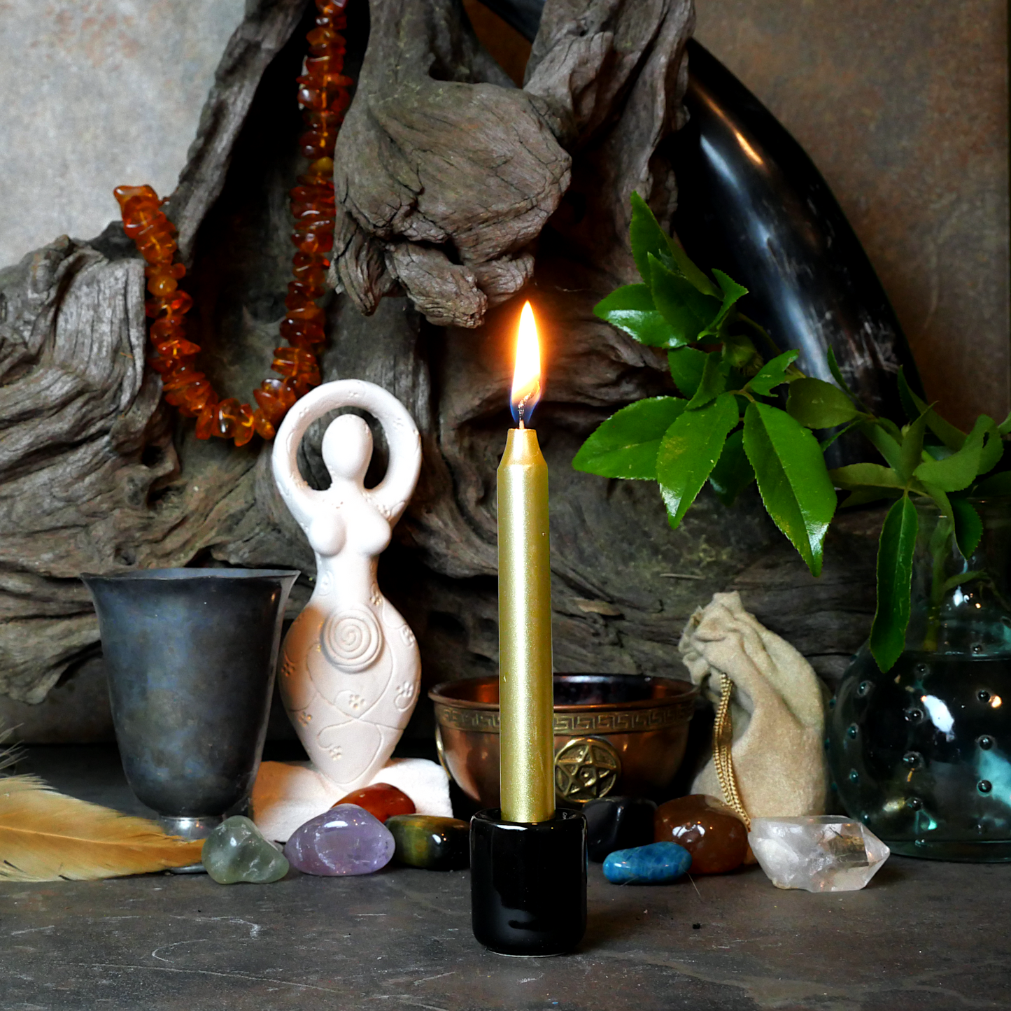 A lit Metallic Gold Chime Candle, in a personal altar display, showing how it might be used in a ritual or ceremonial setting
