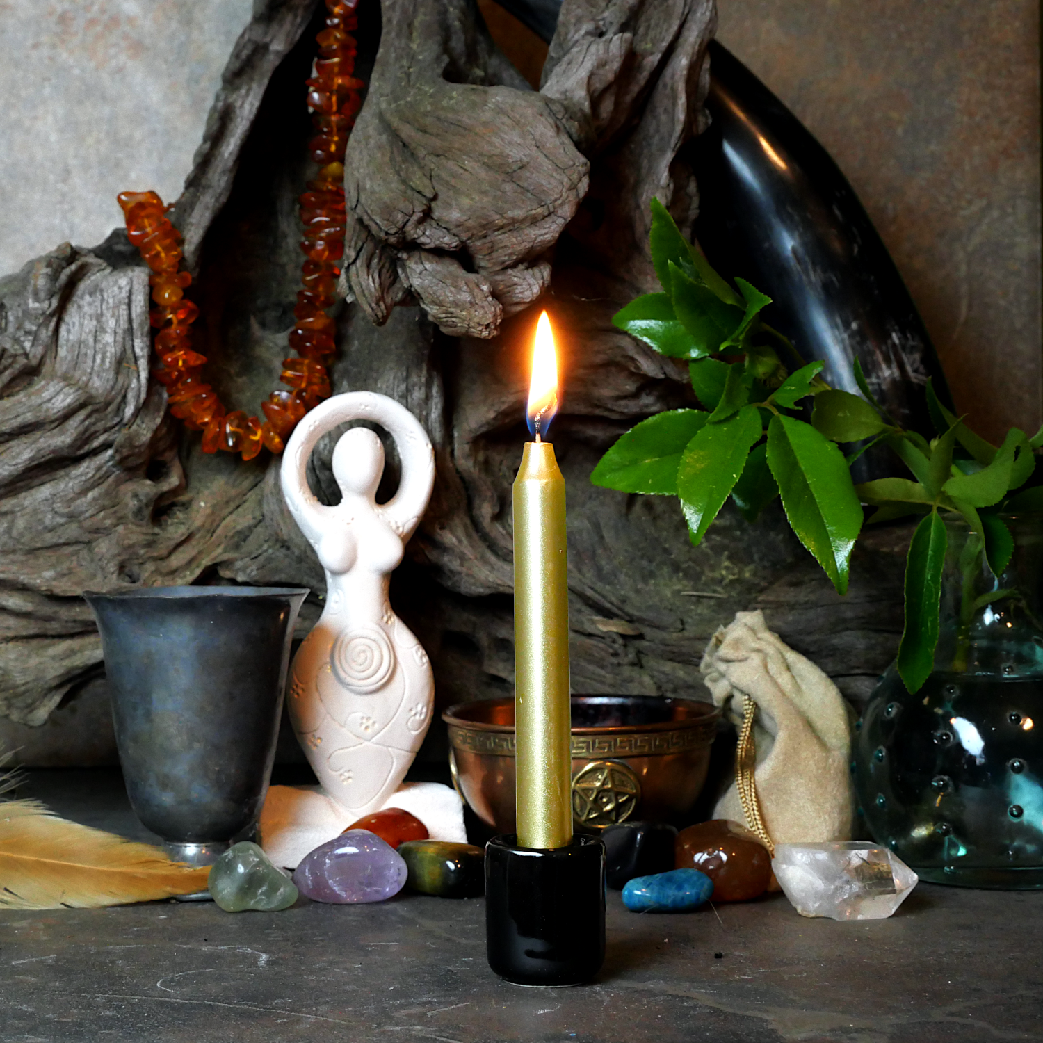 A lit Metallic Gold Chime Candle, in a personal altar display, showing how it might be used in a ritual or ceremonial setting