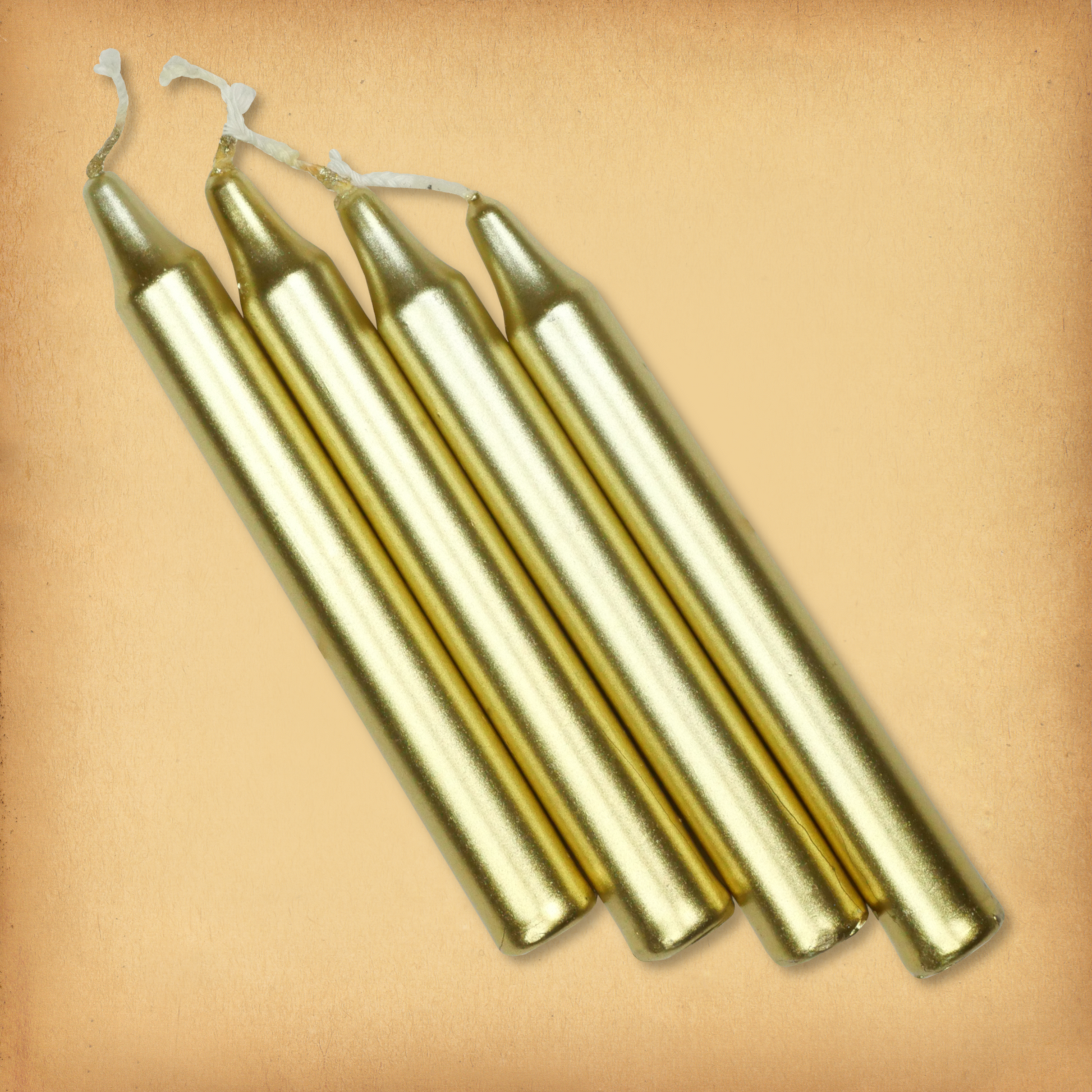 An overhead view of four Metallic Gold Chime Candles, diagonally placed on a plain surface, showing the candles' proportions.