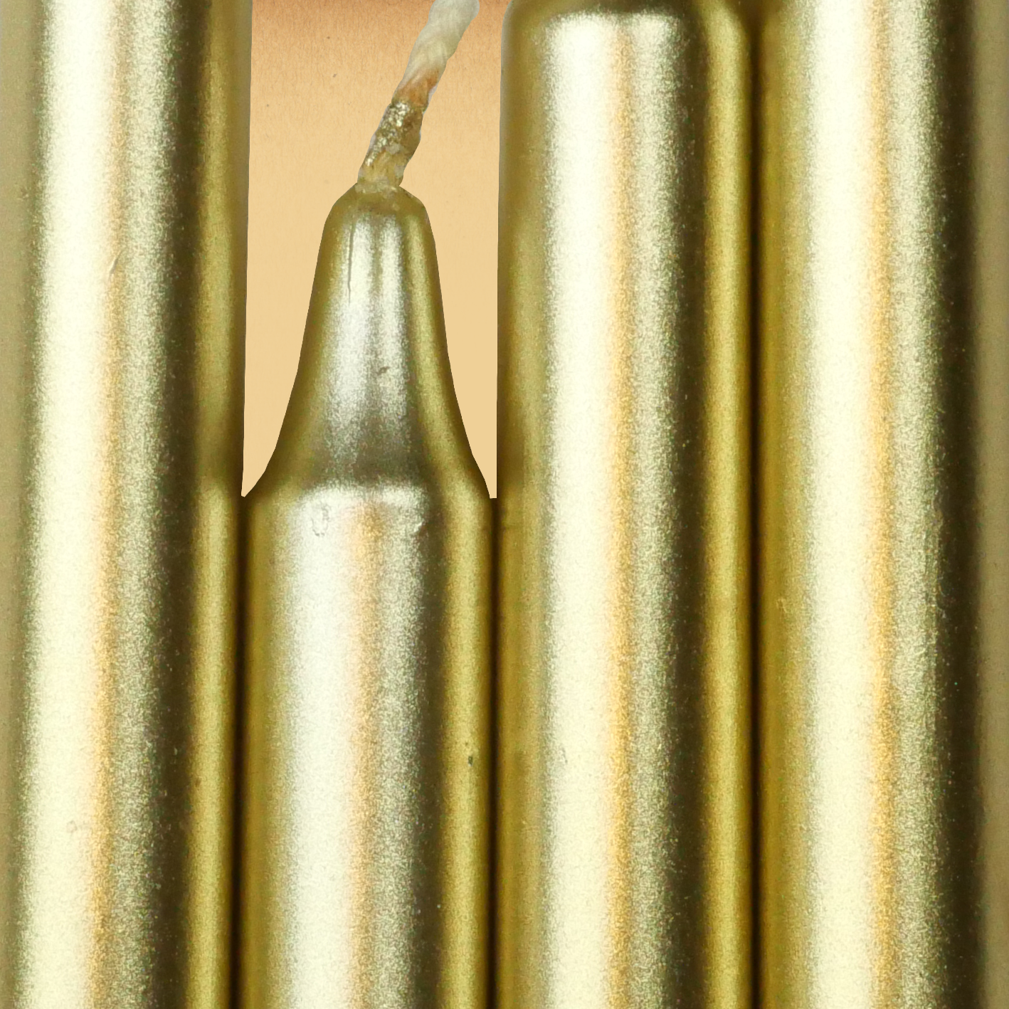 Closeup of a quartet of Metallic Gold Chime Candles arranged side-by-side so they form an almost solid block of color.