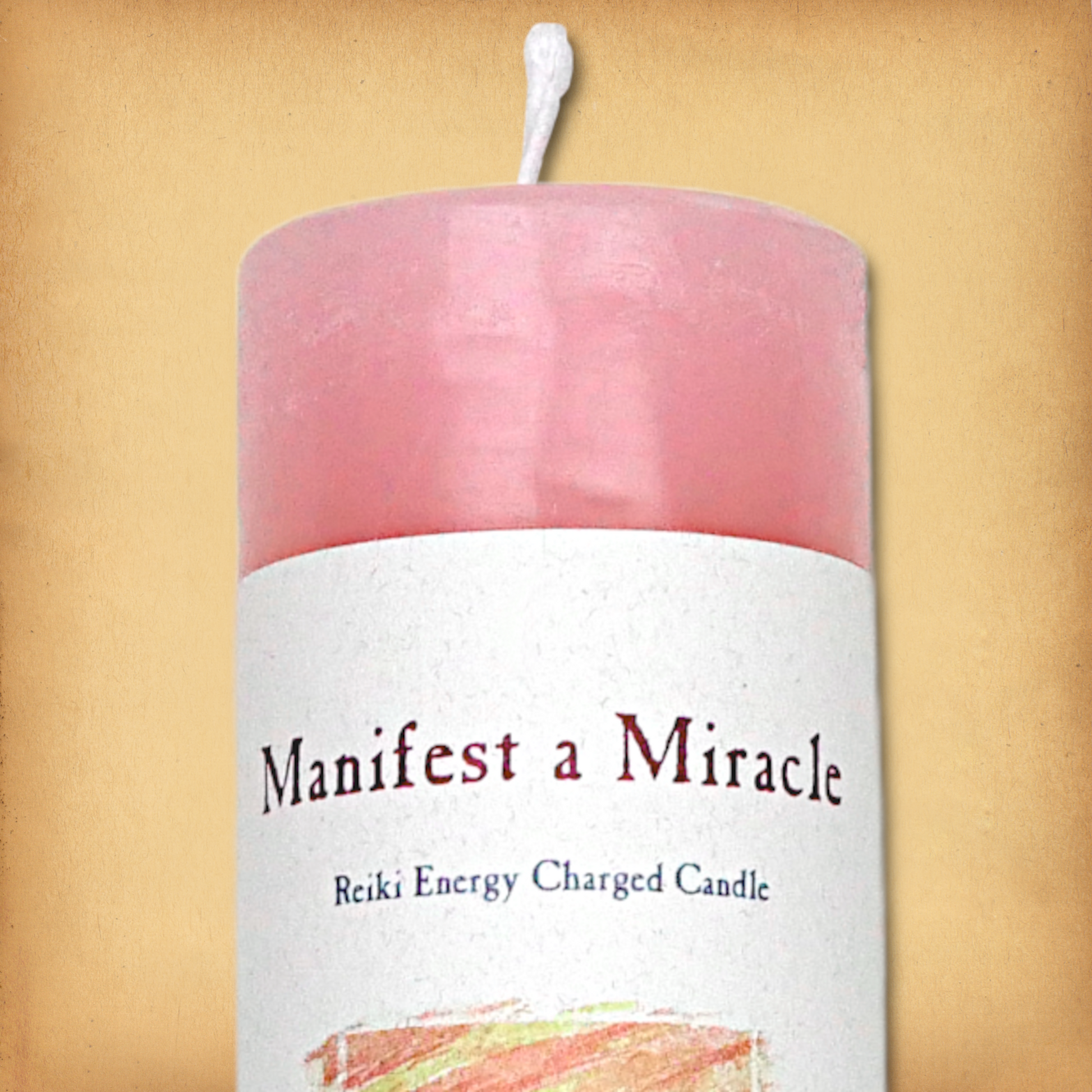 Pink pillar candle labeled “Manifest a Miracle” with “Reiki Energy Charged Candle” beneath. Slim pillar candle, single wick.
