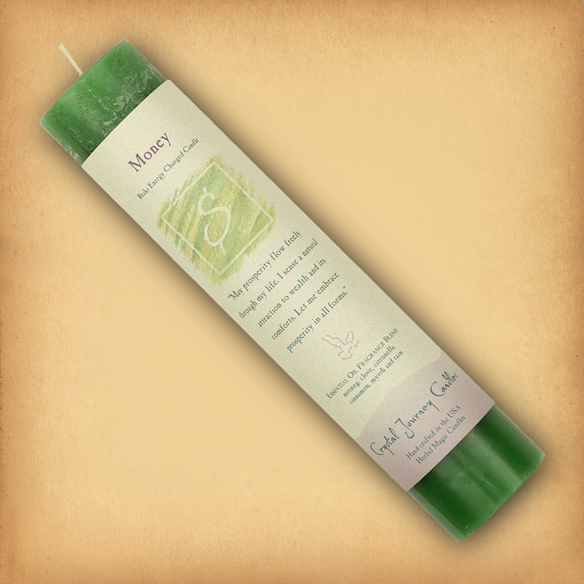 Green Reiki-charged Money Pillar Candle, displayed diagonally to show its label with affirmation and essential oil blend.