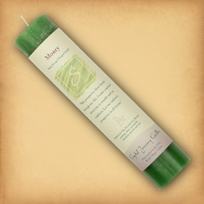 Green Reiki-charged Money Pillar Candle, displayed diagonally to show its label with affirmation and essential oil blend.