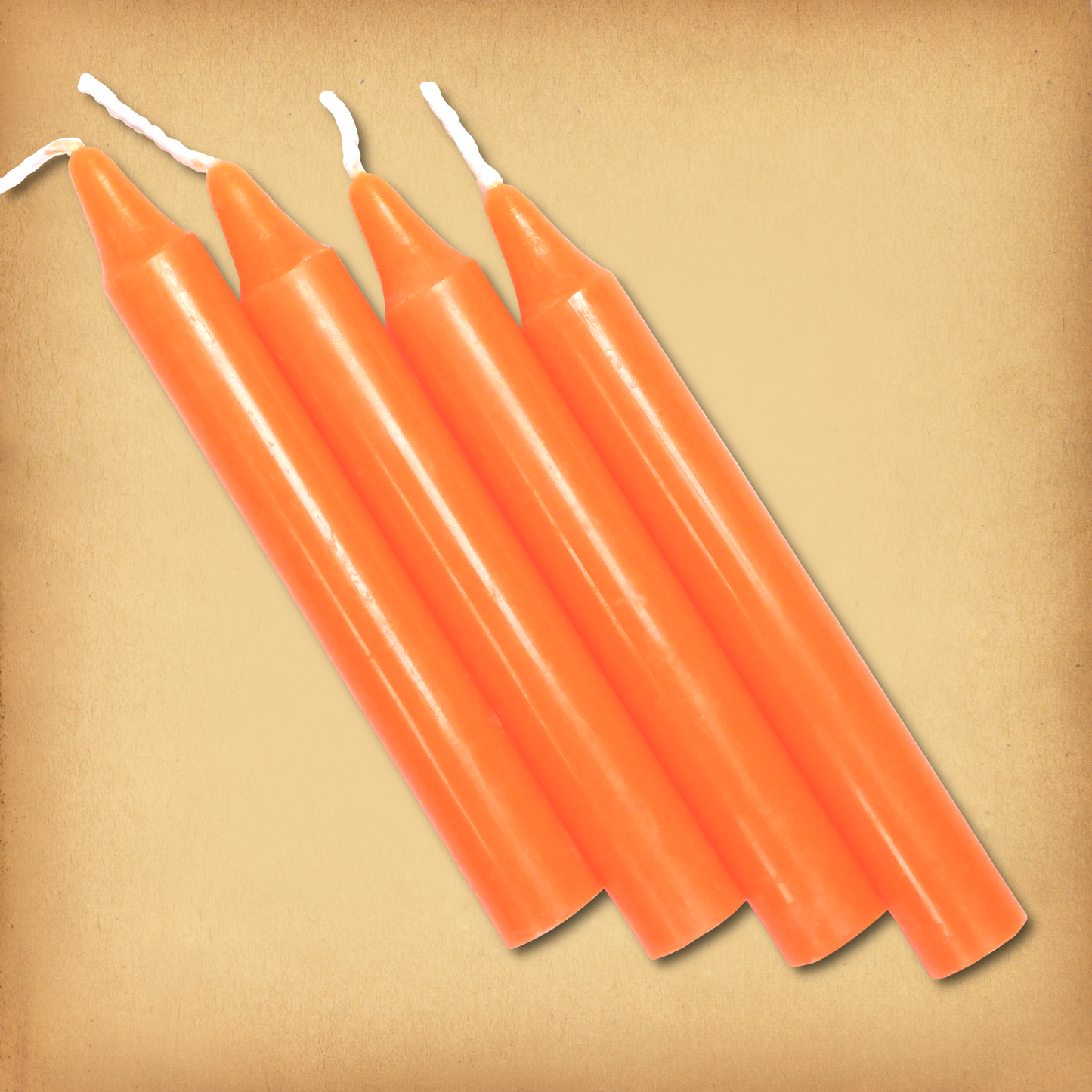 An overhead view of four Orange Chime Candles, diagonally placed on a plain surface, showing the candles' proportions.