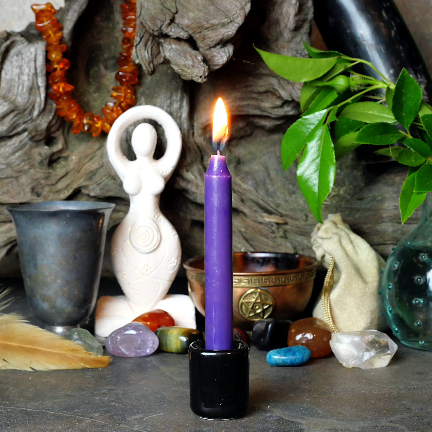 A lit Purple Chime Candle, in a personal altar display, showing how it might be used in a ritual or ceremonial setting.
