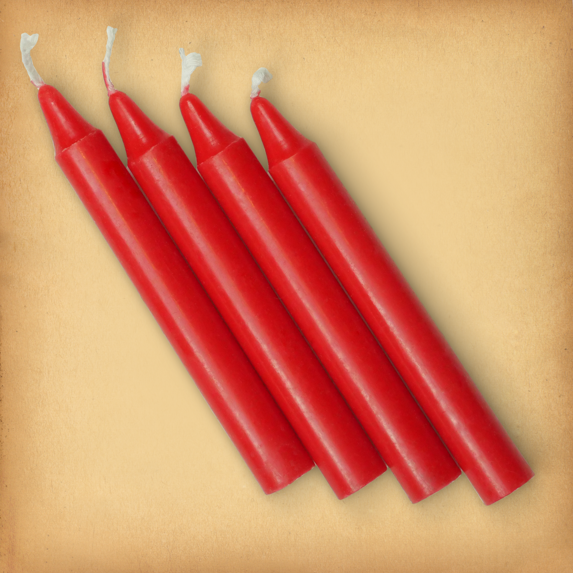 An overhead view of four Red Chime Candles, diagonally placed on a plain surface, showing the candles' proportions.