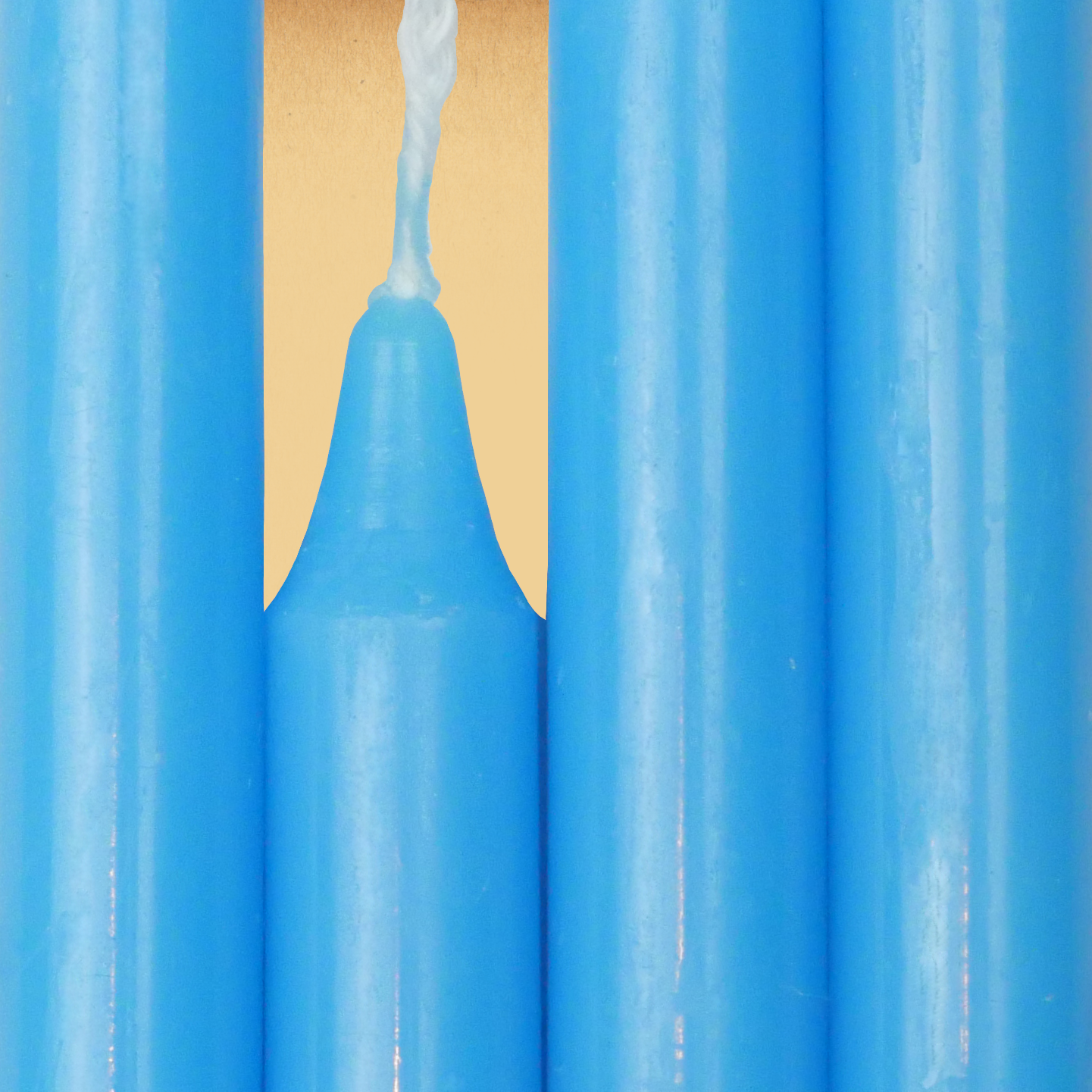Closeup of a quartet of Sky Blue Chime Candles arranged side-by-side so they form an almost solid block of color.