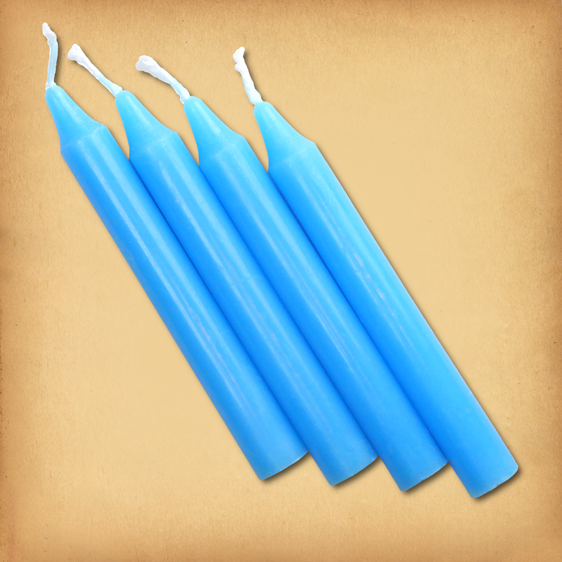 An overhead view of four Sky Blue Chime Candles, diagonally placed on a plain surface, showing the candles' proportions.