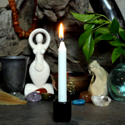 A lit White Chime Candle, in a personal altar display, showing how it might be used in a ritual or ceremonial setting.