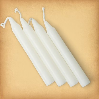 An overhead view of four White Chime Candles, diagonally placed on a plain surface, showing the candles' proportions.
