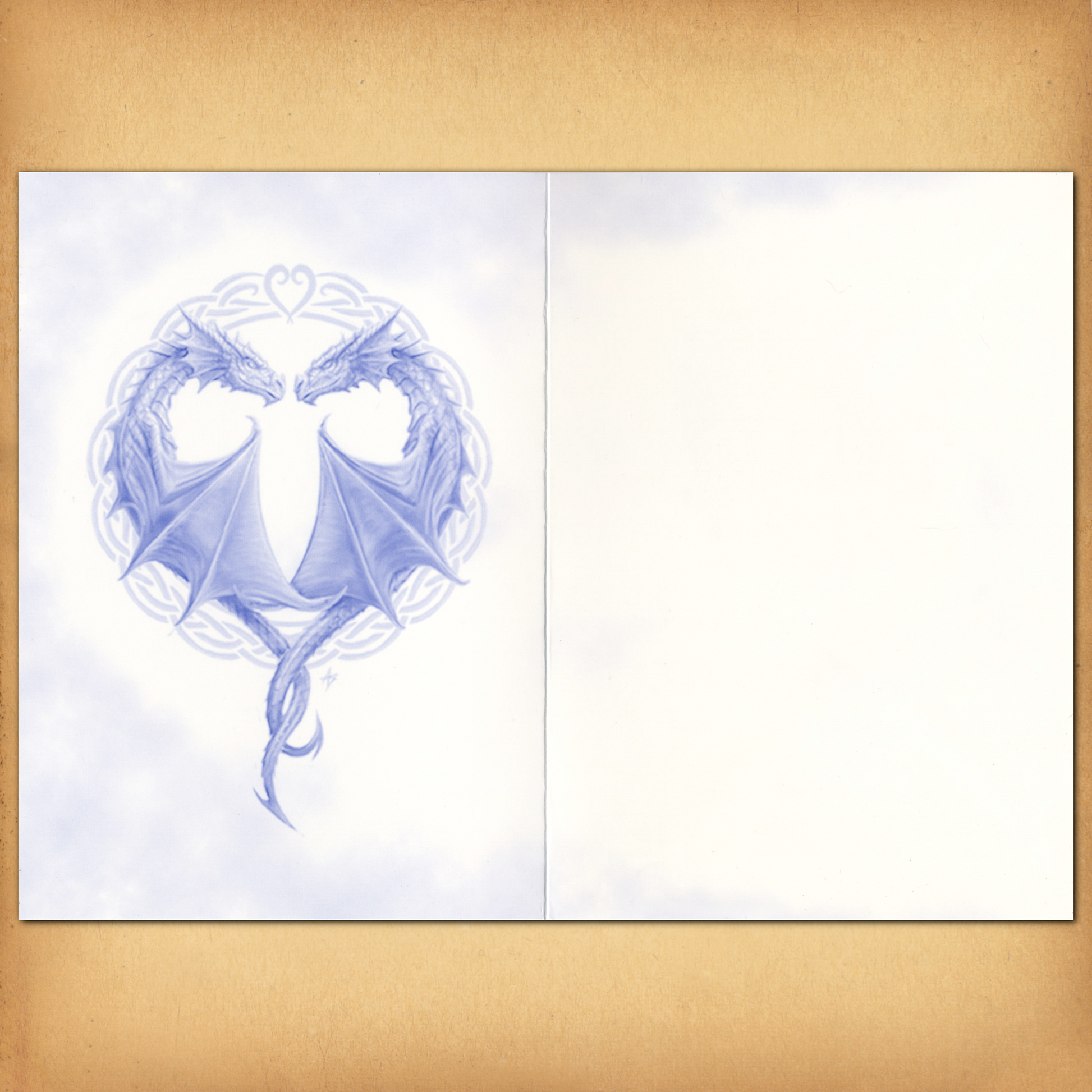 Monochromatic art inside the card, of two dragons with tails intertwined to form a heart shape. There is no text.
