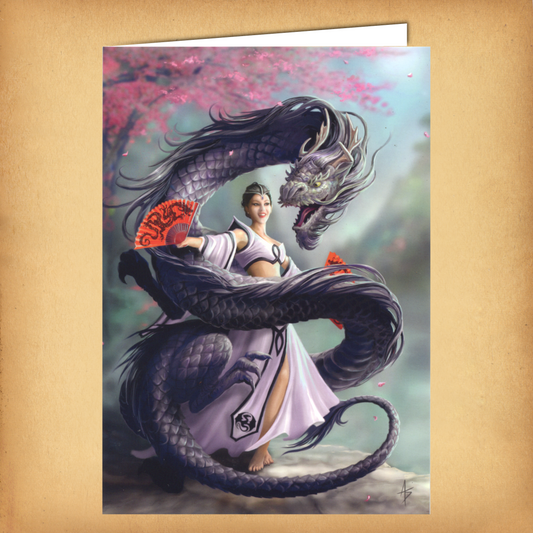 Fantasy greeting card featuring a graceful dancer in white gown twirling with a sinuous black dragon beneath cherry blossoms.