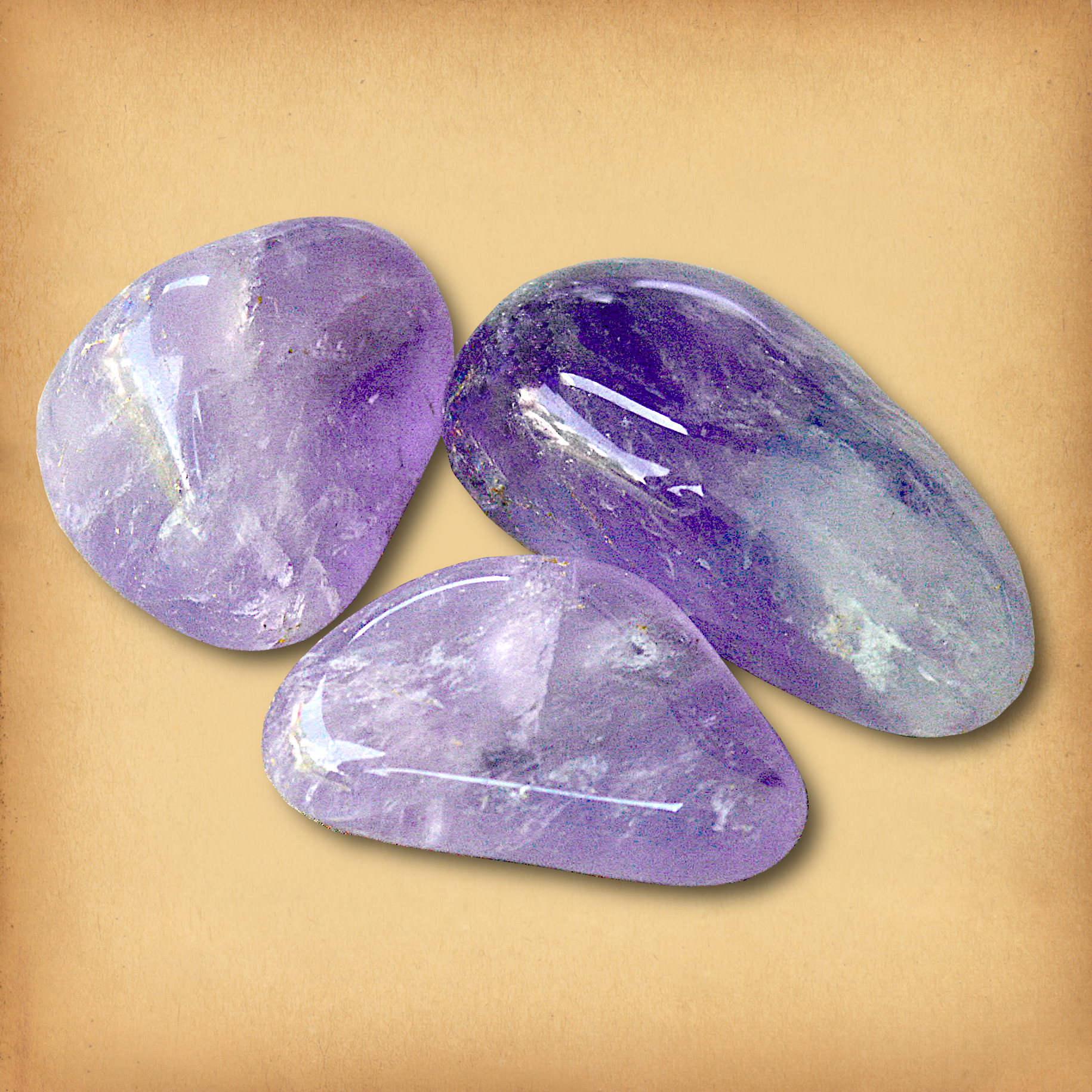 Three tumbled Amethyst stones, in soft lavender to deep purple hues, demonstrating the typical variety in a set.