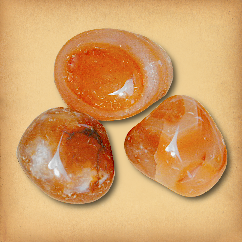 Three tumbled Carnelian gemstones in translucent orange hues with natural marbling demonstrating the typical variety in a set