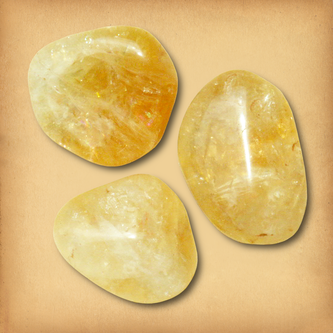 Three tumbled Citrine gemstones in warm golden hues, with translucent and opaque areas, showing the typical variety in a set.