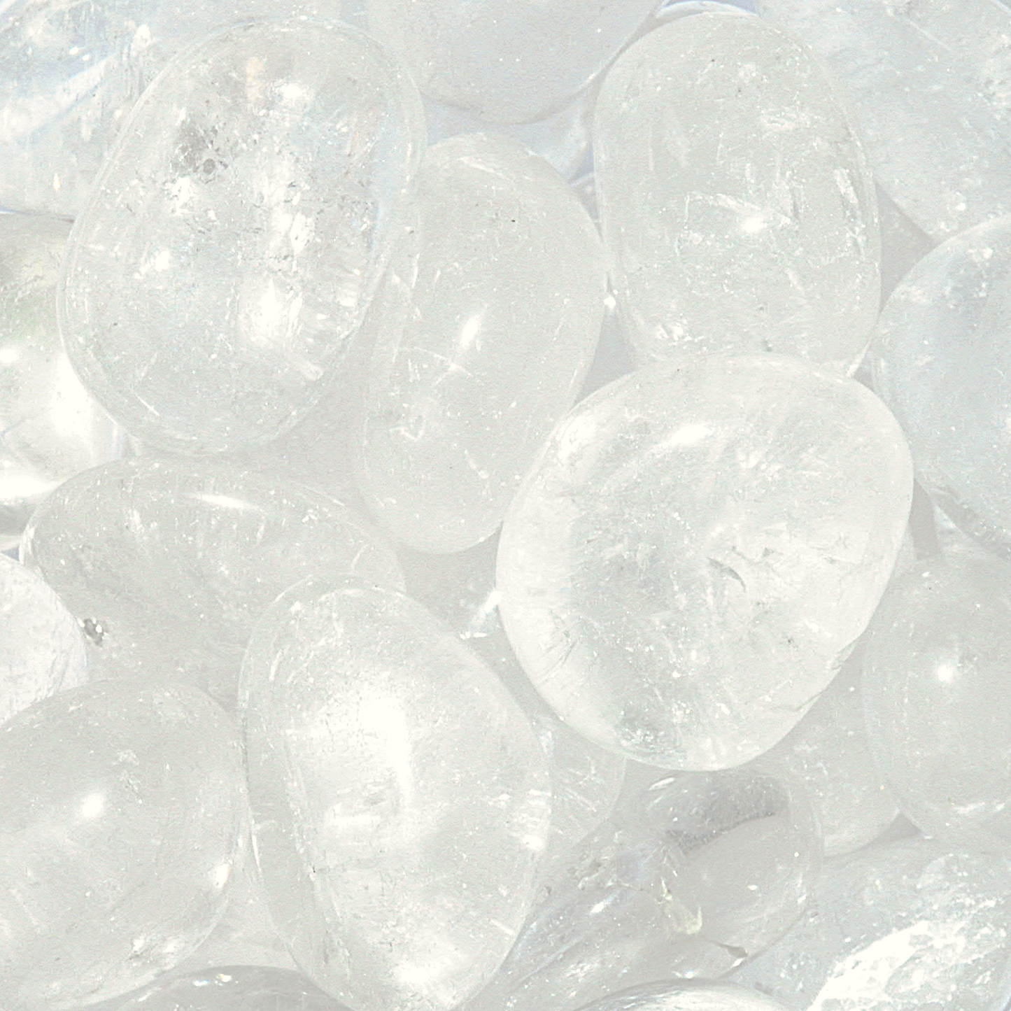 Tumbled Clear Quartz gemstones, crystal-clear, with occasional wisps of translucent white, and a smooth polished finish.