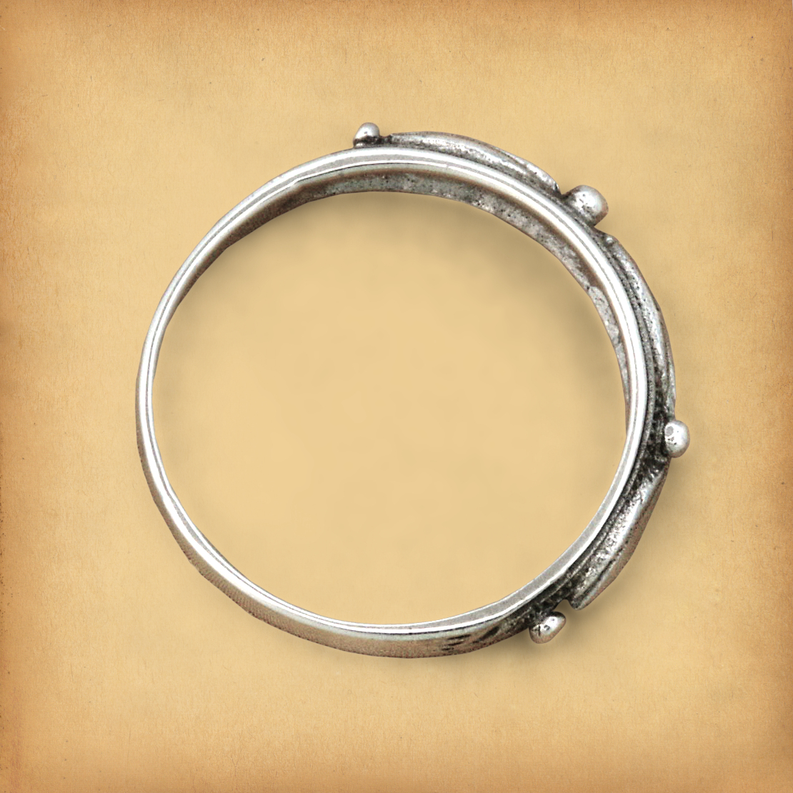 "Touch of Silver" Ring, displayed flat, showing that the geometric accents are found only on the top half of the ring.