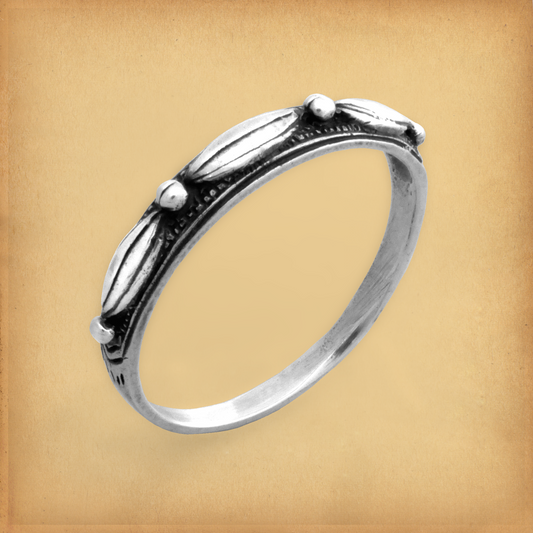 "Touch of Silver" Ring, featuring a delicate design of raised geometric accents on a minimalist sterling silver band.